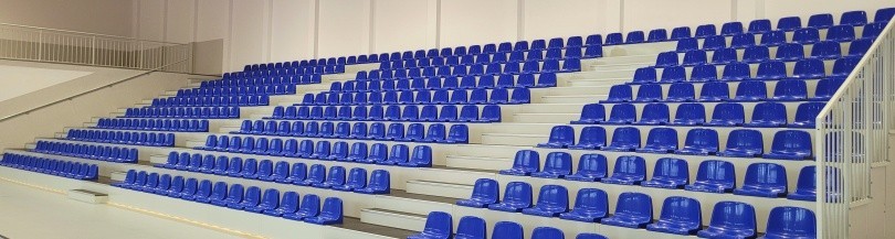 Trybuny składane teleskopowo i stałe o stalowej konstrukcji na hale sportowe